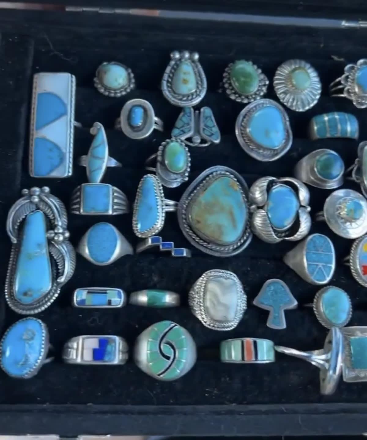 Case of vintage turquoise and sterling silver rings including Navajo cluster work and Zuni channel inlay, bought by California Vintage Buyers
