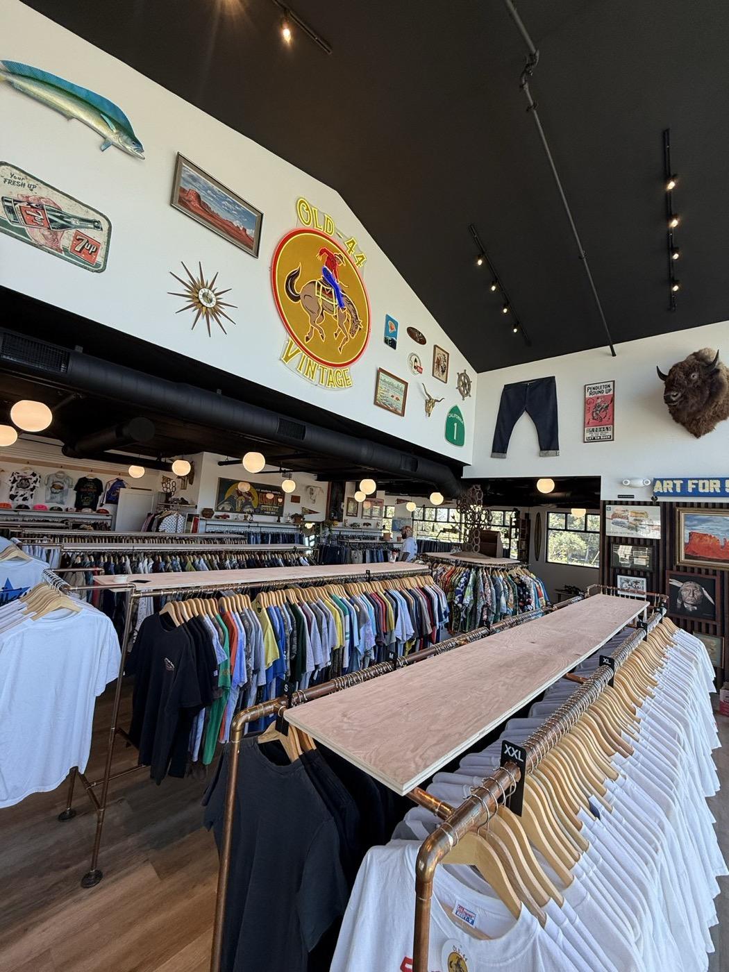 Inside Old 44 Vintage: racks of vintage t-shirts and denim under the shop's signage wall