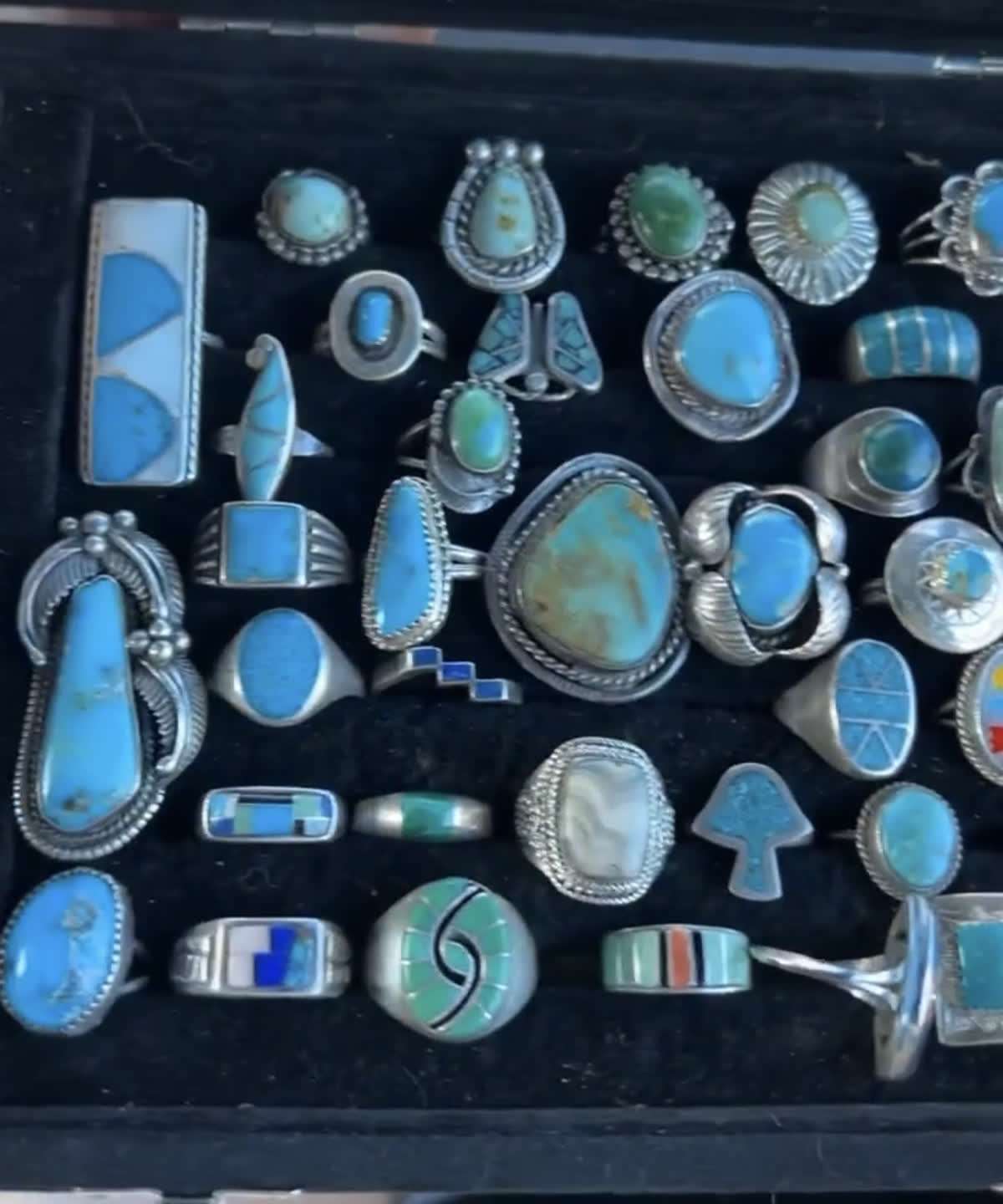 A case of vintage turquoise rings from a single house call, cluster work and channel inlay on black velvet