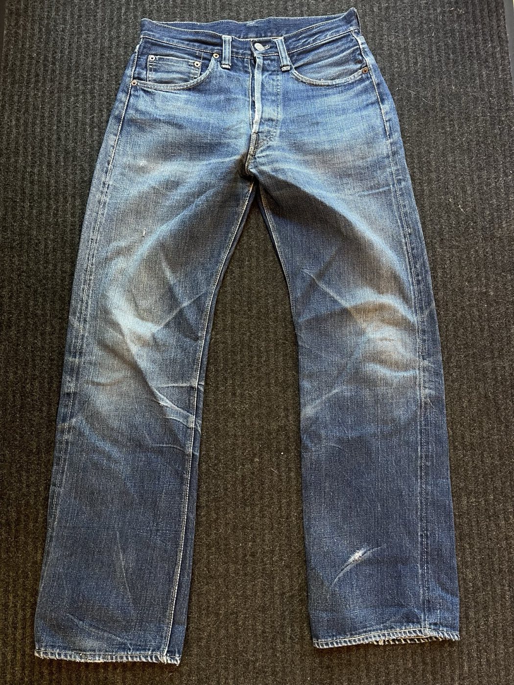1940s Levi's 501XX jeans with one-sided red tab and strong honeycomb fading, laid flat