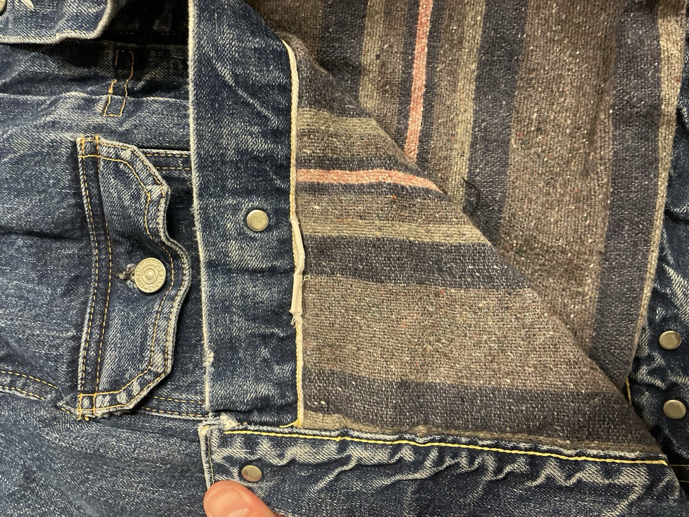 Striped blanket lining inside a worn 1950s Levi's Type 2 denim jacket
