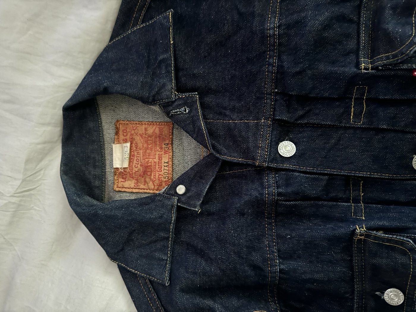 Close up of the paper patch on a Levi's 507XX Type 2 reading 507XX W34, Every Garment Guaranteed