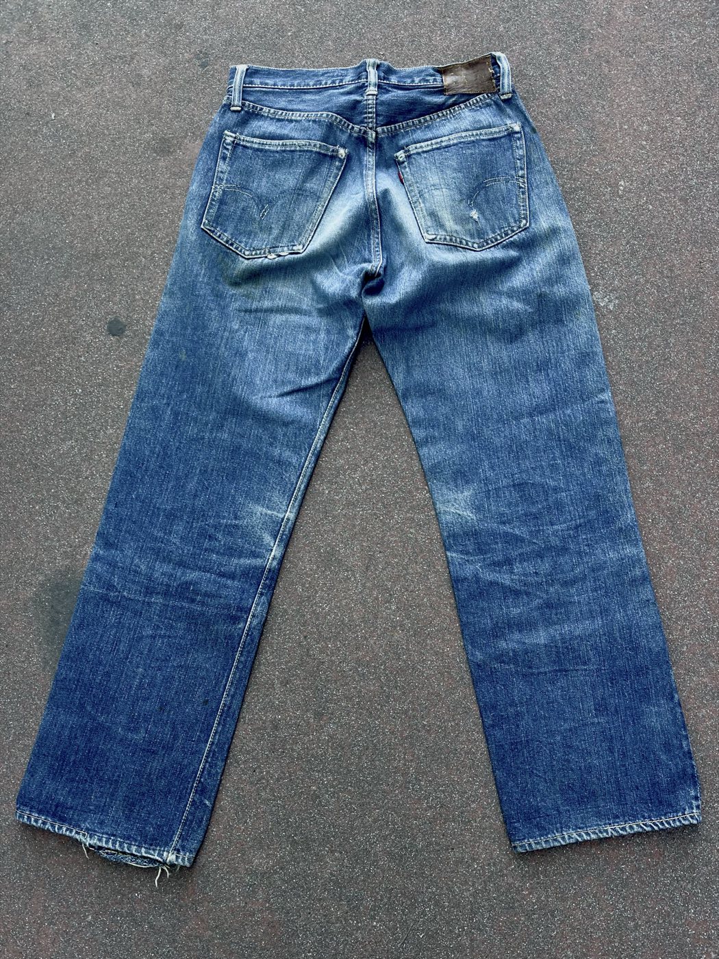 Rear view of vintage Levi's jeans with strong natural fading across the seat and legs